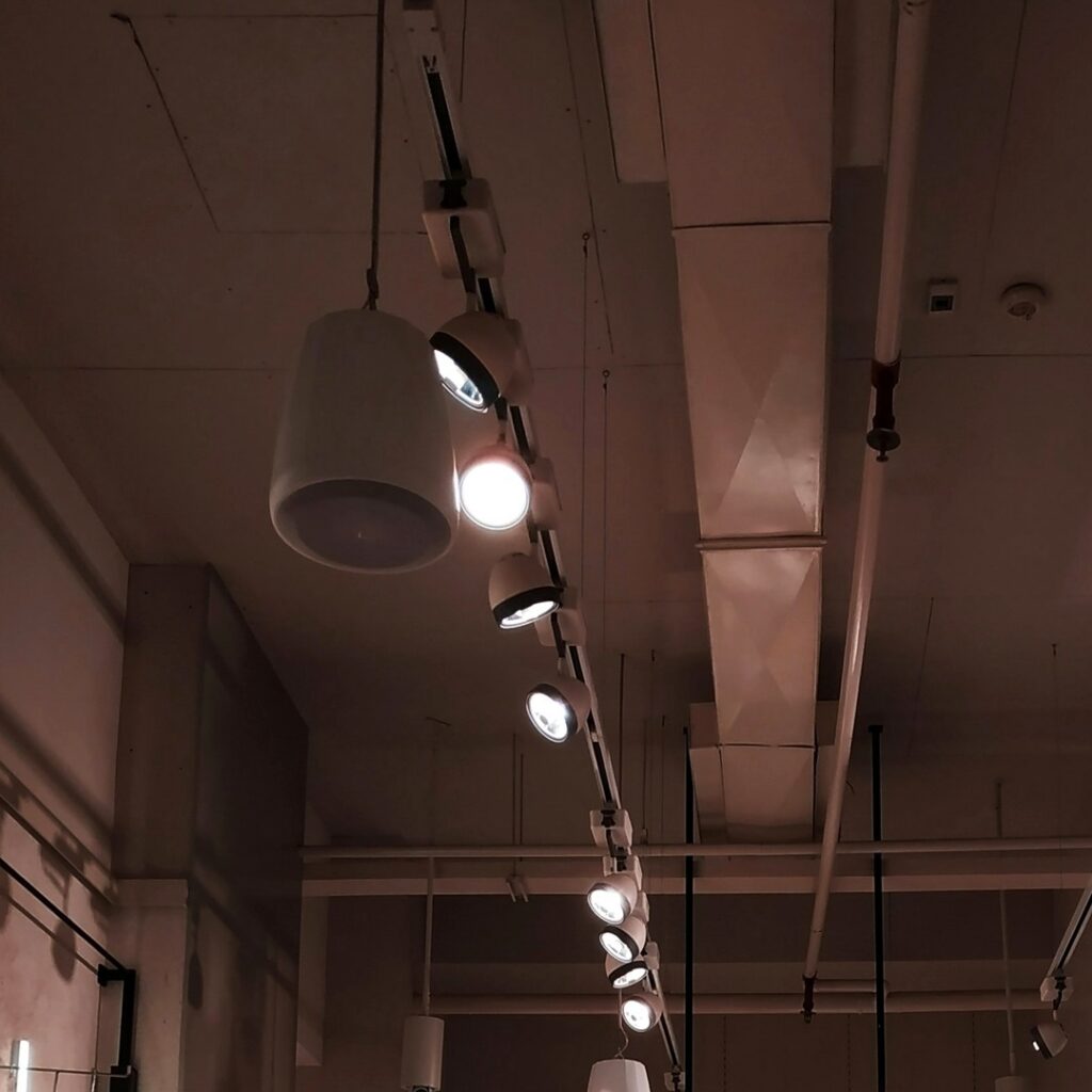Image of track lighting from a retail ceiling | QTC Retail Solutions